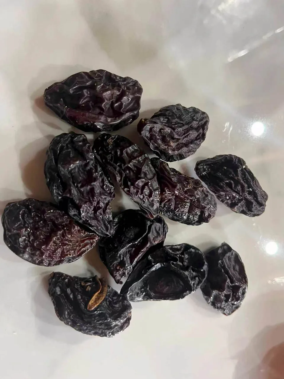 Sample of Agen prunes displayed on a light surface.